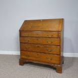 A George III oak Bureau, with feather banded and shell inlay, sloping front enclosing fitted