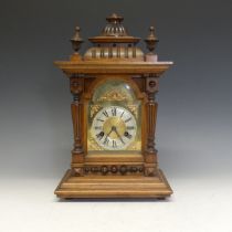 A 19th century German mahogany mantle Clock, textured brass dial with Roman chapter and decorative