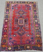 Tribal Rugs; an old Caucasian Rug, red ground with three central medallions within a geometric