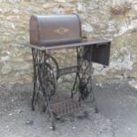 A Vintage treadle style Singer sewing Machine on stand, black painted metal base, W 102 cm x H 101