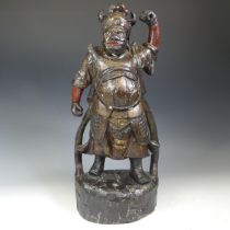 An antique Chinese carved wood figure of a Warrior, in the Ming style, black and gilt decoration,