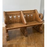 A Victorian pitch pine Gothic Sew seat, once from a larger Pew, W 131 cm x H 83 cm x D 68 cm.