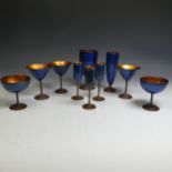 A set of French enamel on copper Drinking Vessels, comprising Flutes, Martini Glasses and Goblets,