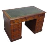 A Victorian mahogany pedestal Desk, with green skived leatherette top, knee hole flanked by three