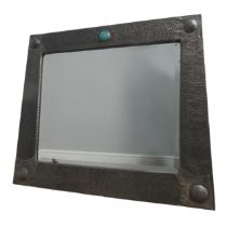 An Arts and Crafts pewter wall Mirror, of graduating rectangular shape, hammered frame with strapped