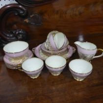 A Shelley pink ground and gilt pattern Tea Set, comprising six Tea Cups and Saucers, six Bread