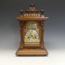 A 19thC German mahogany mantle Clock, textured brass dial with Roman chapter and decorative