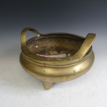 A large late 19thC Chinese gilt-bronze tripod Censer, with twin handles raised on three legs,