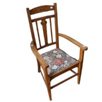 An Arts and Crafts Oak Armchair, with inlaid stylised flowers to back, floral upholstery, raised