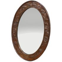 A Scottish Arts and Crafts copper oval wall Mirror, frame with embossed stylised flowers and