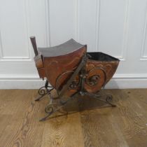 An Arts and Crafts copper Coal Scuttle, in the manner of Christopher Dresser, with swing handle