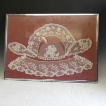 A framed display of three panels of antique Honiton Lace including collars, frame size 63cm x 46cm