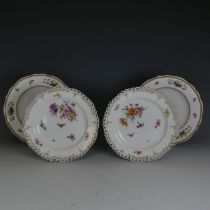 A pair of early 20thC KPM Berlin porcelain Cabinet Plates, with reticulated lace edge, enclosing