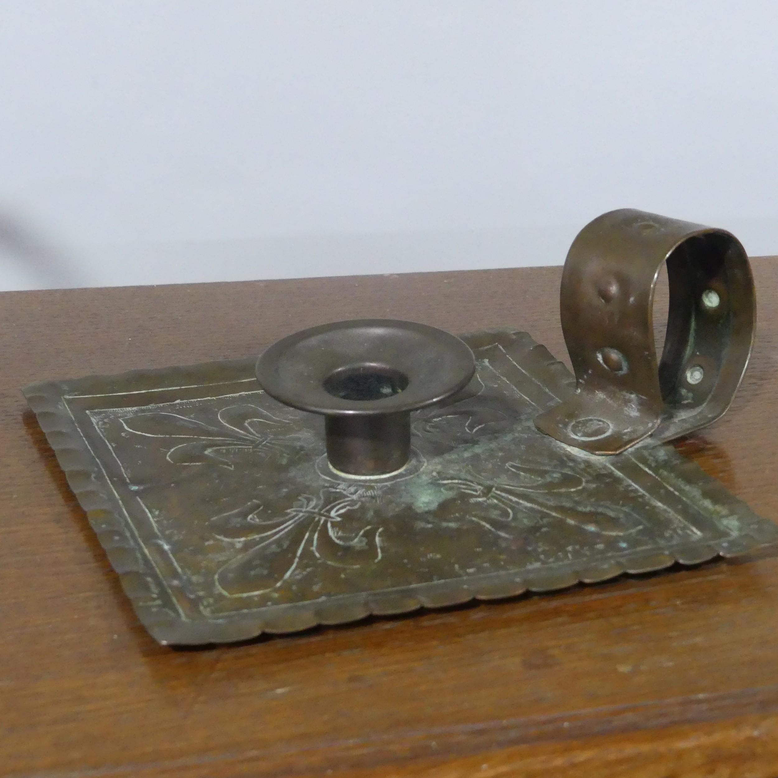 An Arts and Crafts copper Chamber Stick, unmarked, together with an Antique copper Kettle, copper