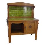 A Liberty style Arts and Crafts oak Washstand, of a high quality, with green tiled back and top,