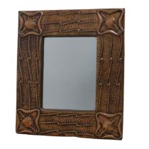 An Arts and Crafts rectangular wall Mirror, beaten frame with corners embossed with stylised