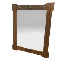 A Pair of Arts and Crafts oak rectangular wall Mirrors, with metal foliate plaques to top and