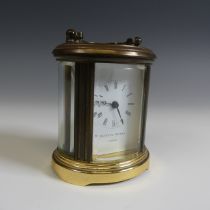 A miniature Matthew Norman oval five glass carriage Clock, H 8 cm.