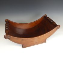 A George III mahogany Cheese Coaster, curved form with turned roundels to each end, W 46 cm x H 18