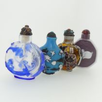 An antique Chinese overlayed glass Snuff Bottle, with blue upon transparent glass, depicting bats,