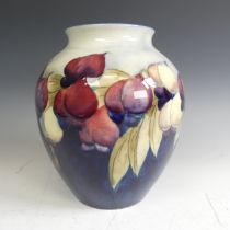 A William Moorcroft 'Wisteria' pattern Globular Vase, with typical tubelined decoration on blue