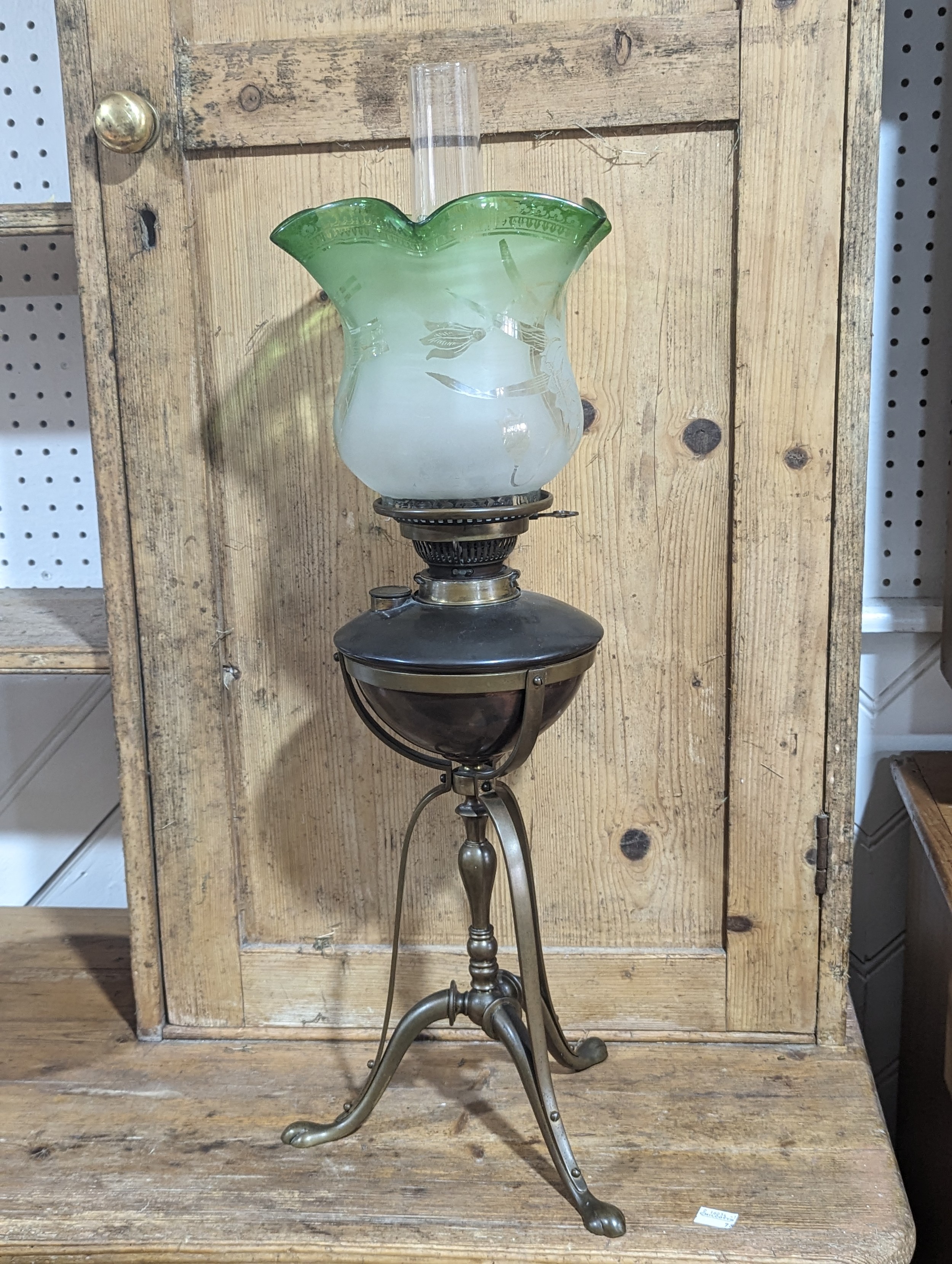 An late 19thC Oil Lamp, with acid etched glass shade, raised on copper and brass tripod stand,