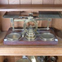 A set of S Mordan & Co brass Postal Scales, on a wooden base with a set of brass weights, from