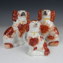 A pair of 19th century Staffordshire pottery Dogs, of small size, H 12.5cm, together with another