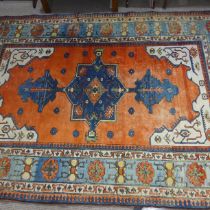 Tribal Rugs; a Turkish hand knotted 100% wool rug, the orange ground woven with bold geometric