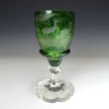 A large Bohemian glass type Goblet, the green bowl etched with deer amongst trees, on fluted lobed