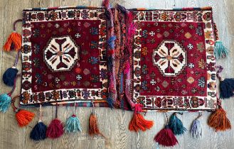 Tribal Rugs; a large Baluchi tent bag/camel bag, 146cm x 80cm, together with a large rug-backed