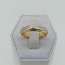 A 22ct yellow gold and platinum Ring, the gold band with an applied central engraved platinum