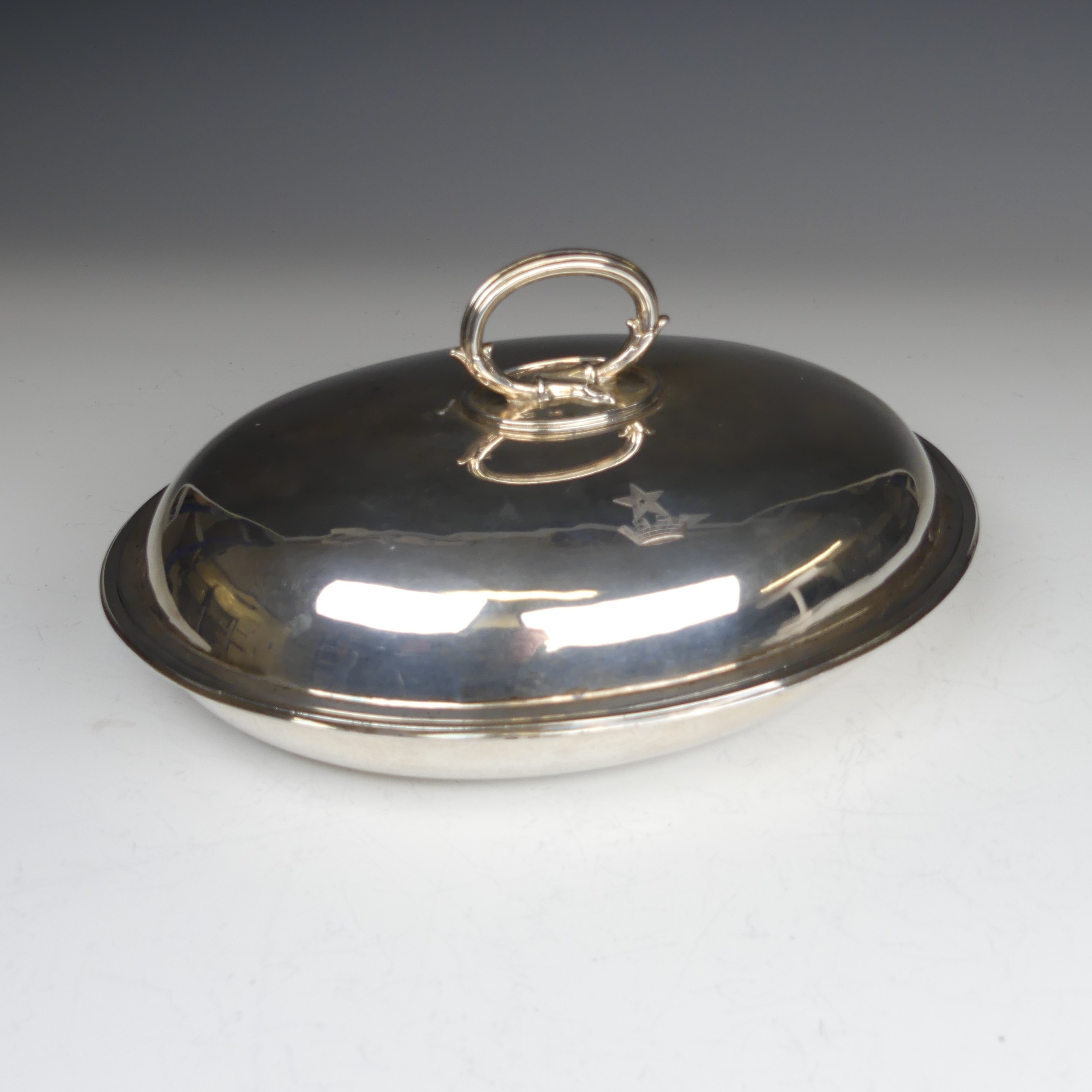 A Victorian oval silver Entrée Dish, hallmarked London 1883, with loop handle, crested with Peile