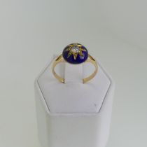 A late Victorian diamond and enamel Ring, the central old cut stone approx. 0.2ct, in gold starburst