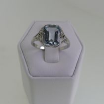 An Art Deco aquamarine and diamond Ring, the central emerald cut aquamarine 8.9mmx7mm, with three