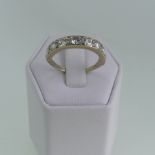 An eight stone diamond half hoop Eternity Ring, the circular cut stones with a total weight of