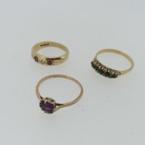 A 9ct yellow gold Band, gypsy set with three rubies and two small diamonds, Size M, together with