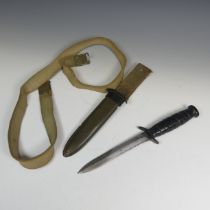 An American USM8 BMCO bayonet Knife, with scabbard and material fittings, blade 17cm.