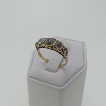 A late Victorian graduated five stone white paste Ring, all mounted on 9ct gold, the shank split,