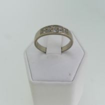 An 18ct white gold Band, the flared front set with two rows of five graduated diamond points, Size