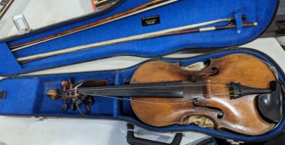 A late 19thC/early 20thC Violin, with one-piece back, overall length 59.5cm, together with two bows,