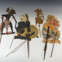 Tribal art; four early 20th century Javanese Wayang Kulit (shadow puppets), formed of ornately