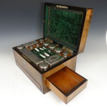 A Victorian walnut Vanity Box, the fitted interior with silver plate mounted glass jars and bottles,