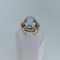 A 14ct yellow gold and zircon Dress Ring, the oval facetted stone 16x11.8mm in a scrolling open