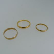 Two 22ct yellow gold Bands, sizes Q and I½, 5g, together with a mis-shapen unmarked ring, tested