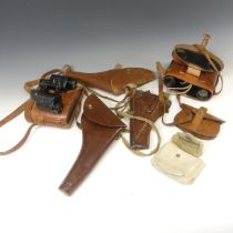 A military leather gun Holster, together with two other similar leather holsters, a leather pouch,