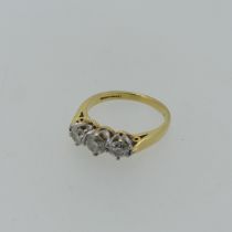 A three stone diamond Ring,the centre stone approx. 0.35ct, with a smaller stone on either side,