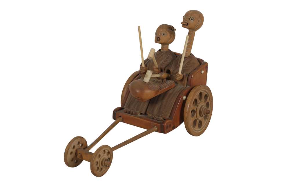 A Wooden Kobe Toy Of Old Couple In Rickshaw