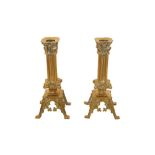 A PAIR OF 19TH CENTURY ROMANESQUE INSPIRED BRASS CANDLESTICKS