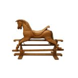 A LATE 20TH CENTURY CARVED PINE ROCKING HORSE